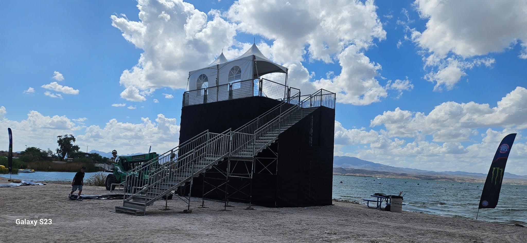 Covered elevated event platform with integrated switchback stairs